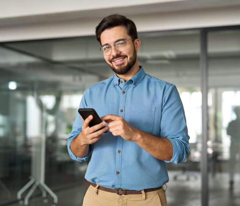 Smiling,Busy,Professional,Latin,Business,Man,Standing,In,Office,Holding