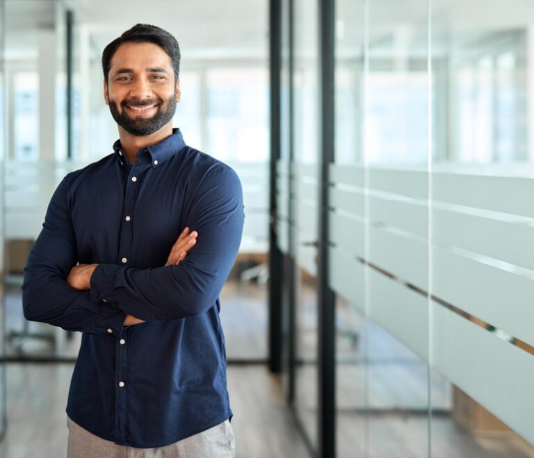 Happy,Indian,Businessman,Professional,Leader,Standing,Arms,Crossed,In,Office.